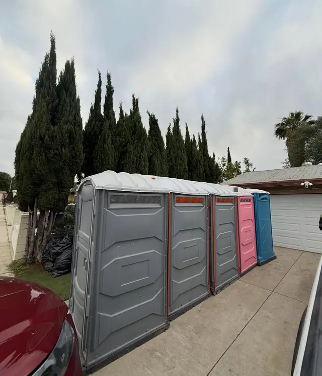 Porta potties lined up on a residential driveway
